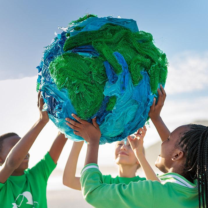 Children holding a globe