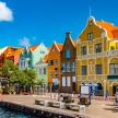 Colorful buildings line the waterfront of Willemstad, the vibrant capital of Curacao, showcasing Dutch colonial architecture